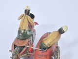 two figurines of a man on a motorcycle and a banana
