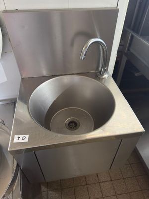 a stainless steel sink in a commercial kitchen