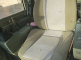 a seat in the back of a vehicle with a cell phone