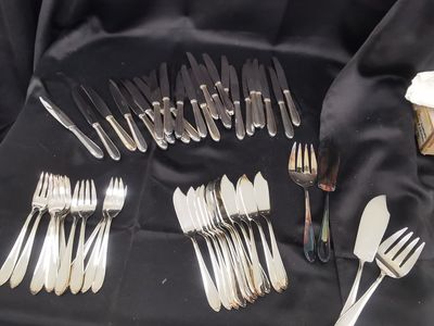 a lot of forks and spoons on a table