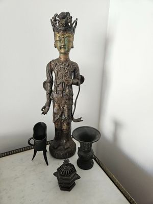 a statue that is sitting on a table next to other items