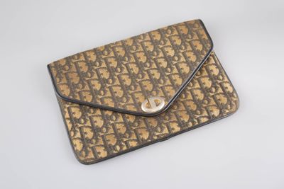 an image of a brown and black purse sitting on top of a white table