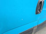 a close up of a door handle on a blue van