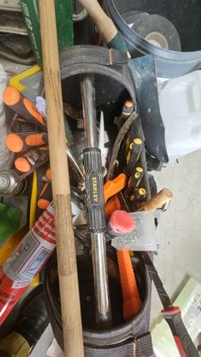 a bucket full of tools sitting on the floor