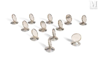 a group of silver colored buttons on a white surface