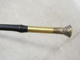 a black and gold pipe sitting on a white cloth
