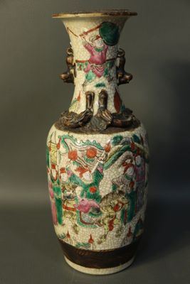 a vase with a design on it sitting on a table