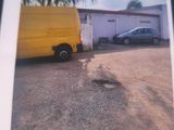 a picture of a picture of a yellow van in a parking lot