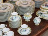 many plates and cups sitting on a table
