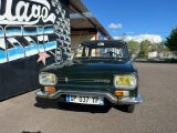 a car parked in front of a building with graffiti on the wall