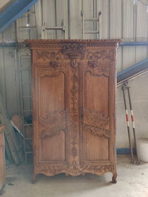 a large wooden cabinet in the middle of a room
