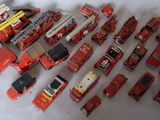 a lot of toy firetrucks and trucks on the table