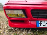 a close up of a red car with a license plate on it