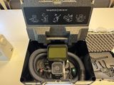 an open case with a camera and other items in it