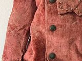 a teddy bear that is wearing a jacket and pants