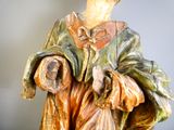 a statue of a woman holding a bag of food