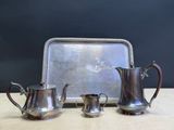 three pieces of silverware sitting on top of a table next to a tray