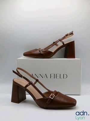 a close up of a pair of brown shoes on a box