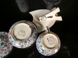 three cups and saucers sitting on a table