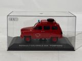 a red toy truck in a clear case on a white surface