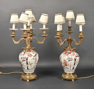 pair of antique chinese vases with lamps on stands on a gray surface