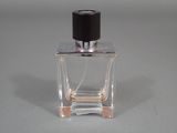 a small bottle of perfume on a table