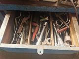 a drawer full of tools that are sitting on top of a table