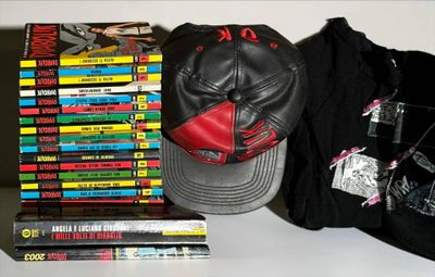 books and a baseball cap are on a table next to a pile of dvds