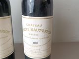 two bottles of wine sitting next to each other on a table