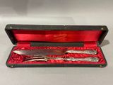a silverware set in a red box on a table