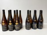 six bottles of wine lined up in a row on a table