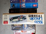 three boxes of model cars sitting on the floor
