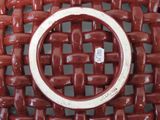 a close up of a red chair with a ring on it
