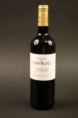 a close up of a bottle of wine on a black background