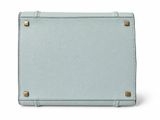 a blue purse sitting on top of a white surface