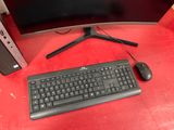 a computer keyboard and a monitor on a red table
