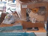many boxes of items sitting on a table in a warehouse