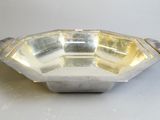 a silver plate with a handle on it sitting on a table