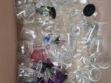 a cardboard box filled with empty plastic bottles and empty wine glasses