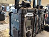 three radio ' s sitting on a table in a room