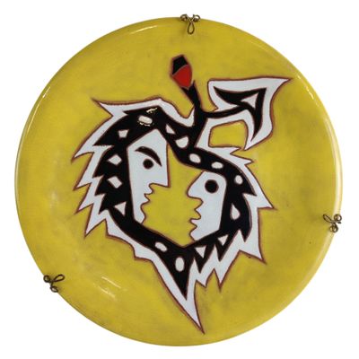 a yellow plate with a black and white design on it
