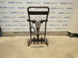 a close up of a machine on a floor in front of a wall