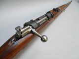 a close up of a rifle on a white surface