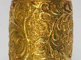 an image of a gold plated cup with a design on it