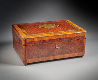 an antique wooden box with a decorative decoration on the lid