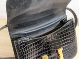 a black purse that is sitting on a table