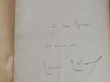 an old book with writing on it sitting on top of a table