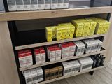 many boxes of cigarettes on a shelf in a store
