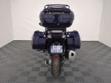 a motorcycle that is parked in a room with a checkered floor