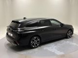 the rear end of a black car in a white room